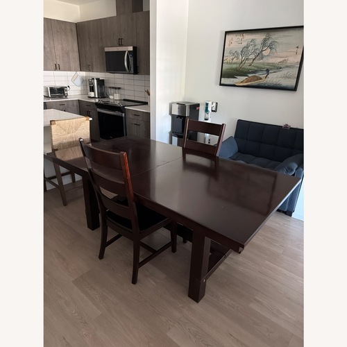 Used Dark Brown Wood Dining Table for sale on AptDeco