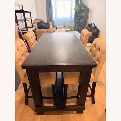 Used Dark Brown Wood Dining Table for sale on AptDeco