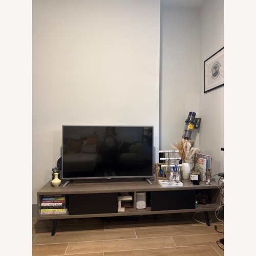 Used Light Wood Tv Stand with Moving Doors  for sale on AptDeco
