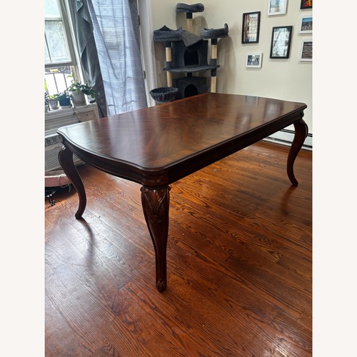 Used Legacy Classic Extendable Wood Dining Table Seats Six for sale on AptDeco