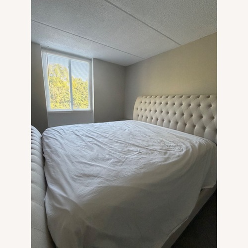 Used Raymour & Flanigan White Fabric King Bed for sale on AptDeco