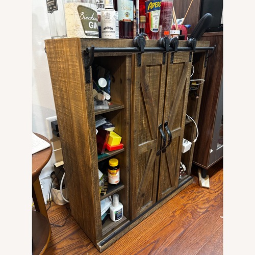 Used Sliding Barn-Door Cabinet Dark Wood for sale on AptDeco