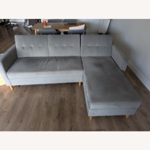 Used Grey Fold-Down Sleeper Sofa with Storage Section for sale on AptDeco