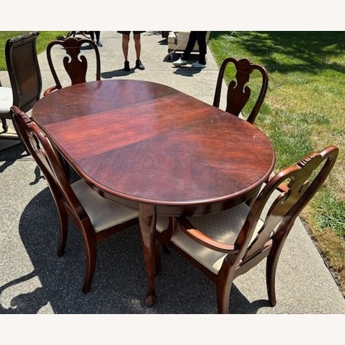 Used Dark Brown Wood Dining Set with 4 Chairs for sale on AptDeco