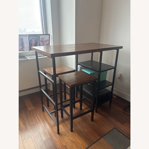 Used Dark Brown Wood Dining Table for sale on AptDeco