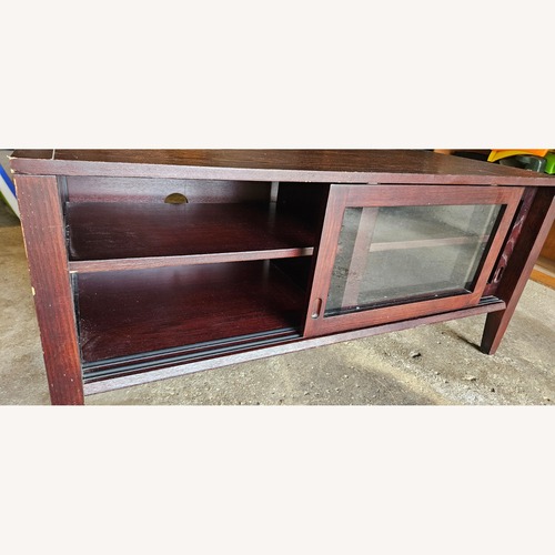 Used Dark Brown Storage Cabinet w Glass Sliding Doors for sale on AptDeco