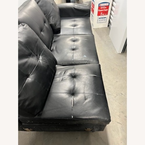 Used Black Sectional Couch With Cup Holder and Storage for sale on AptDeco