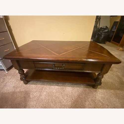Used Ashley Furniture Dark Brown Wood Coffee Table for sale on AptDeco