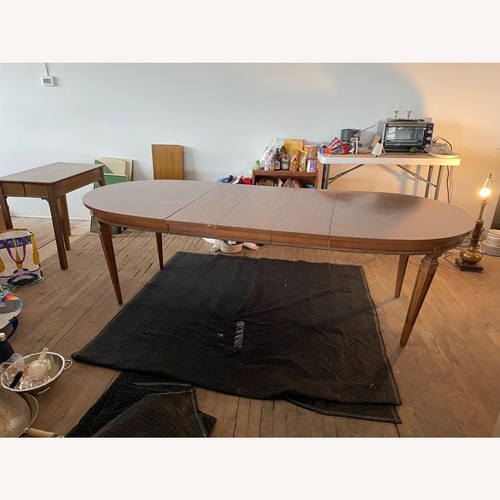 Used Light Brown Wood Dining Table Oval for sale on AptDeco