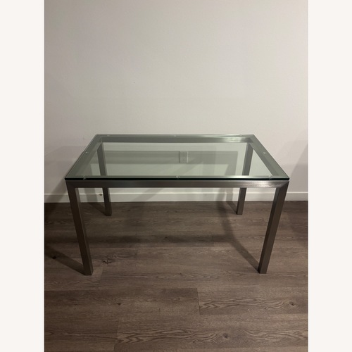 Used Crate & Barrel Parsons Glass Dining Table for sale on AptDeco