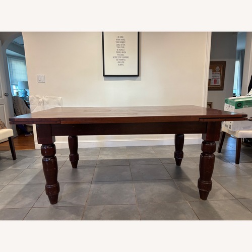 Used Dark Brown/ Red Wood Extension Dining Table for sale on AptDeco