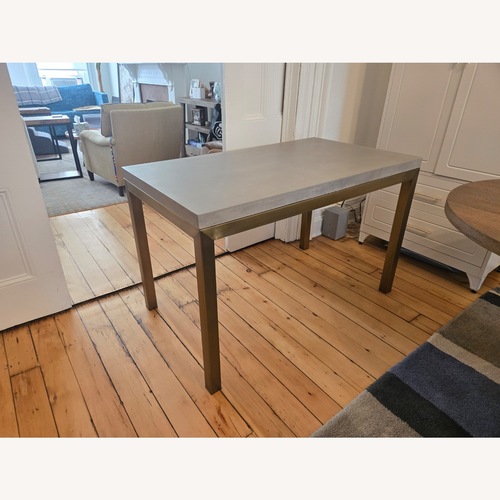Used Crate & Barrel Parsons Concrete and Brass Dining Table for sale on AptDeco