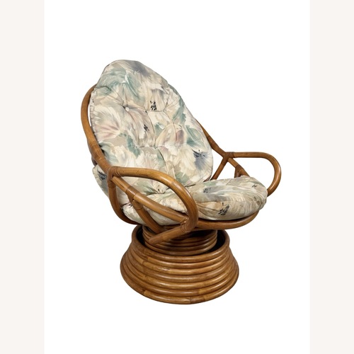 Used Vintage Rattan Swivel Rocker with Floral Cushions for sale on AptDeco