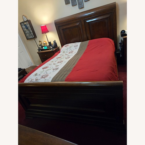 Used Ashley Furniture Dark Brown Wood Queen Bed for sale on AptDeco