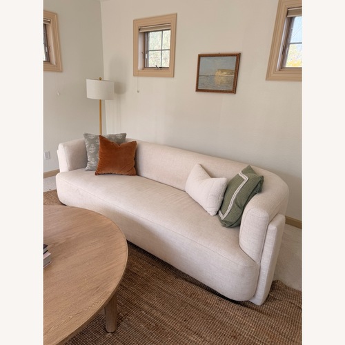 Used Four Hands Hartley Curved Cream Sofa for sale on AptDeco
