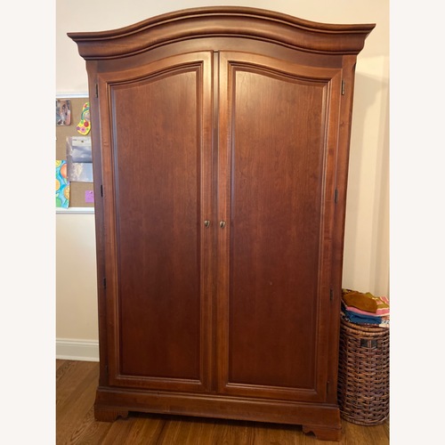 Used Ethan Allen Dark Brown Wood Armoire for sale on AptDeco