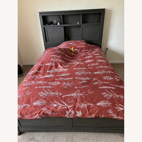 Used Raymour & Flanigan Dark Brown Wood Queen Bed for sale on AptDeco