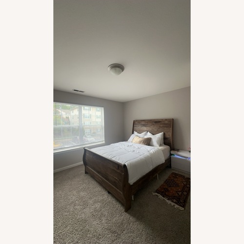 Used Dark Brown Wood Queen Bed for sale on AptDeco