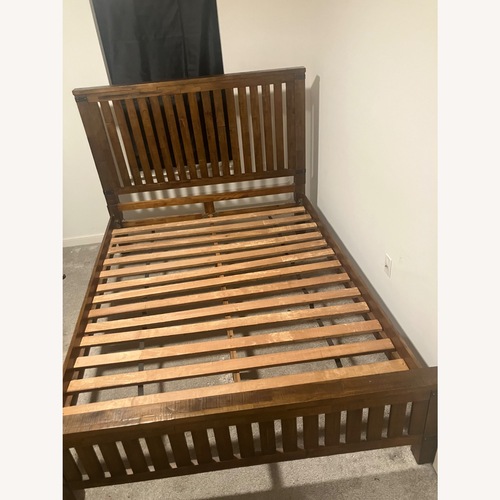 Used Ashley Furniture Dark Brown Wood Queen Bed for sale on AptDeco