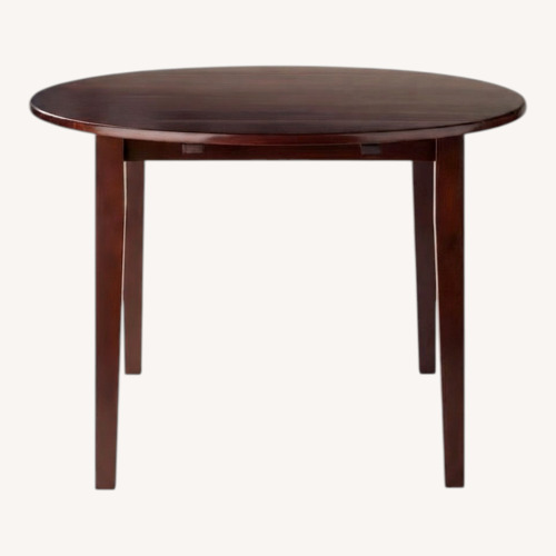 Used Dark Brown Wood Dining Table for sale on AptDeco