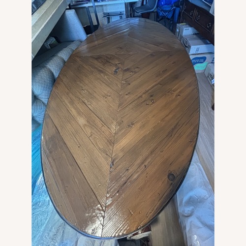 Used Oval Dining Table w Knotty Wood Top & Banded Edge for sale on AptDeco