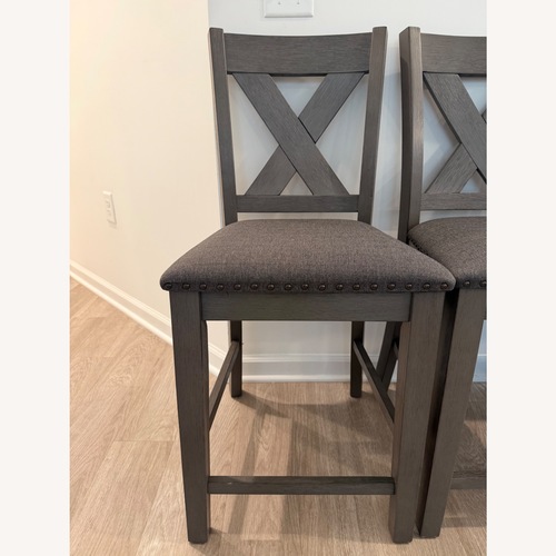 Used Ashley Furniture Dark Gray Wood Bar Stools for sale on AptDeco