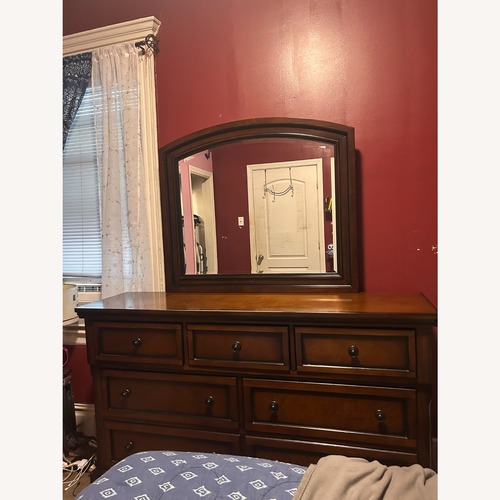 Used Raymour & Flanigan Wood Dresser and Mirror for sale on AptDeco