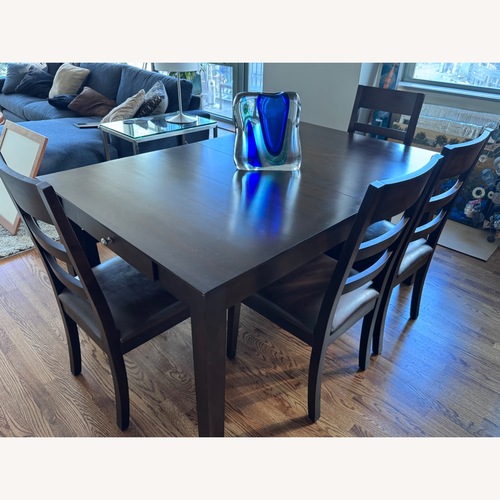 Used Dark Brown Wood Dining Table for sale on AptDeco