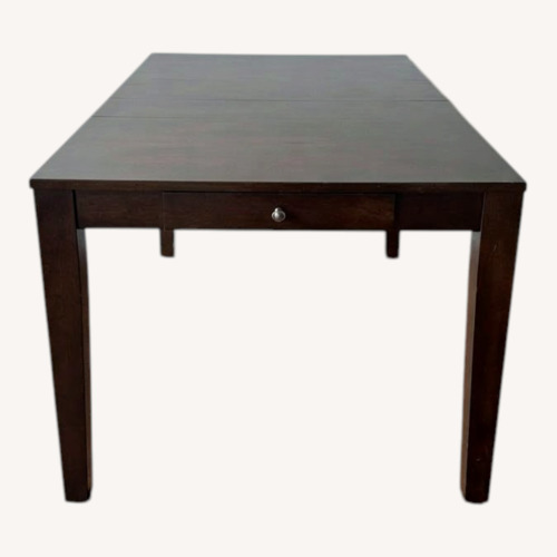 Used Dark Brown Wood Dining Table for sale on AptDeco