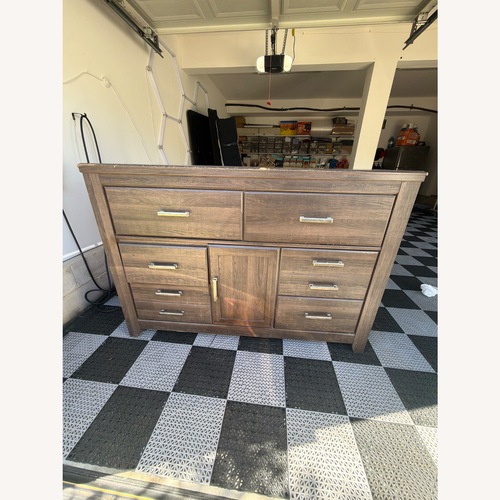 Used Ashley Juararo Dark Brown Dresser for sale on AptDeco