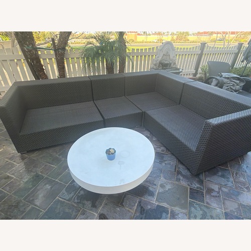 Used Dedon Wicker Corner Group and Matching Side Table for sale on AptDeco