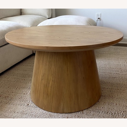 Used Magnolia Wooden Round Pedestal Coffee Table for sale on AptDeco