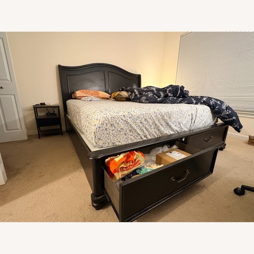 Used Raymour & Flanigan Black Wood King Bed for sale on AptDeco