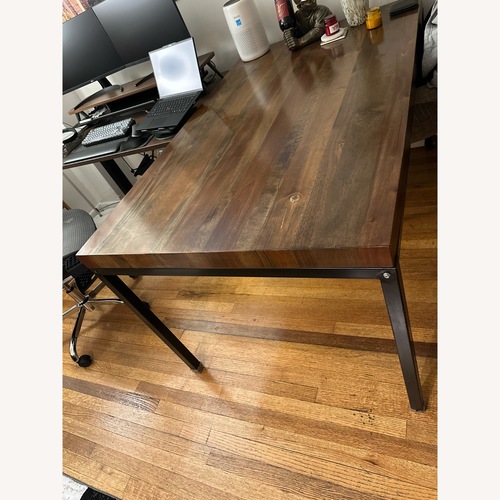 Used Dark Brown Wood Dining Table for sale on AptDeco