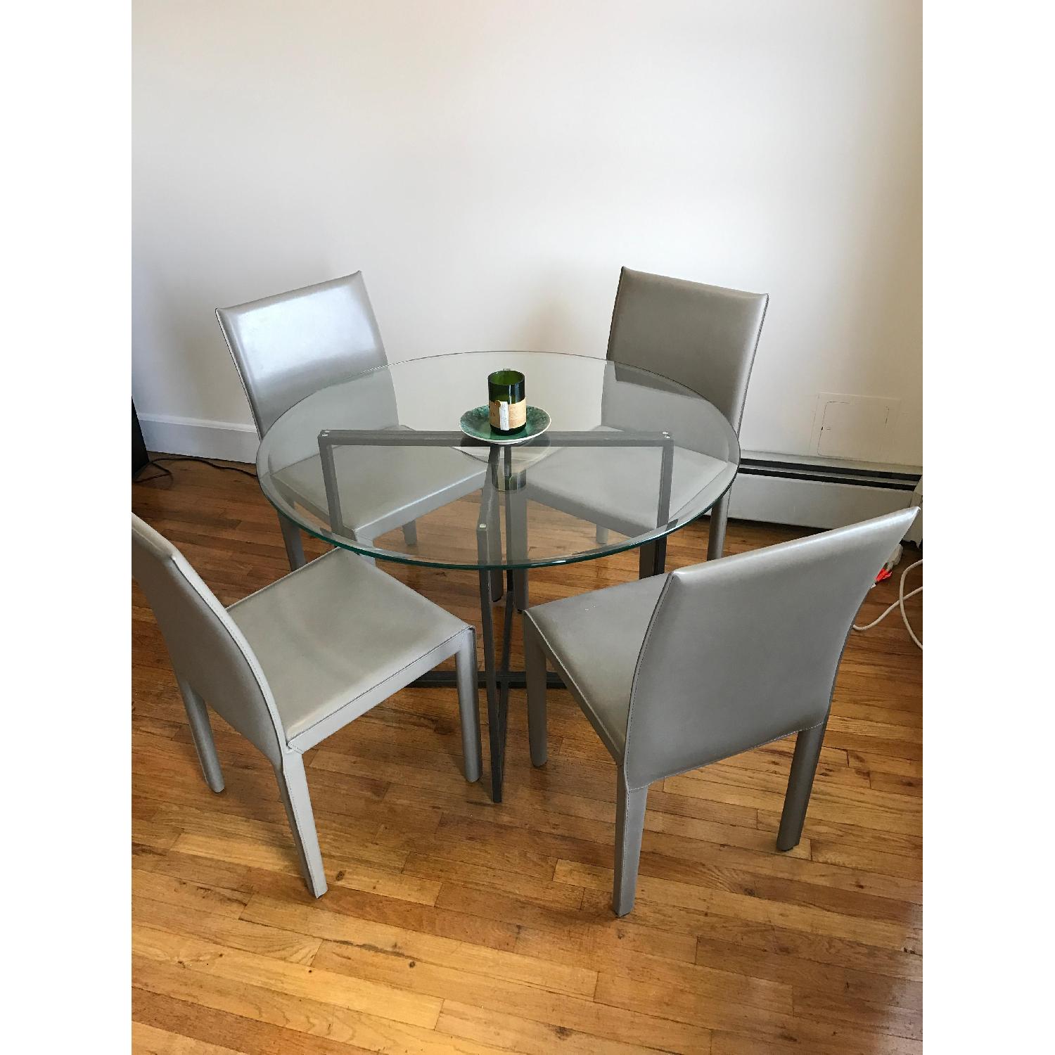 Crate & Barrel Glass Round Dining Table w/ 4 Leather Chairs AptDeco