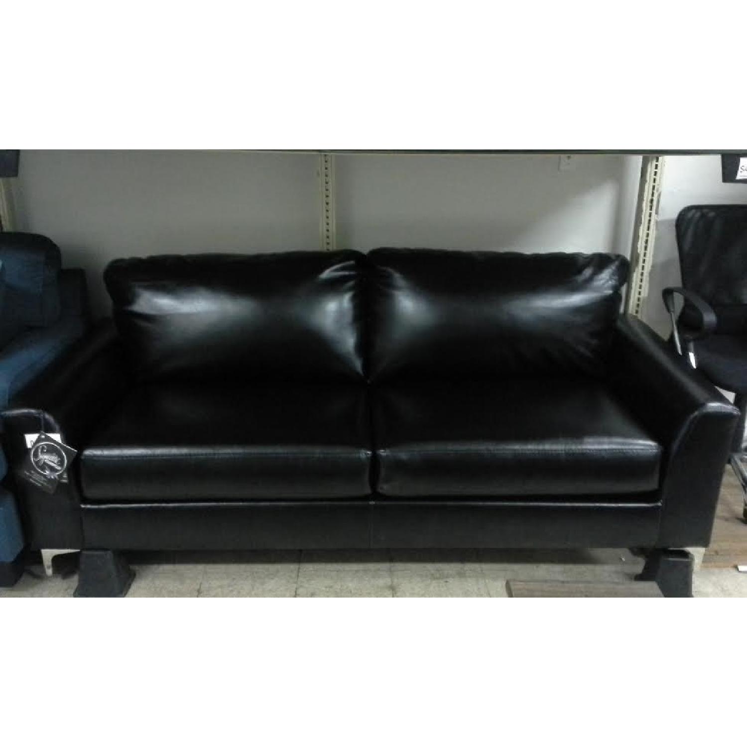 Ashley's Black Faux Leather Sofa - image-1