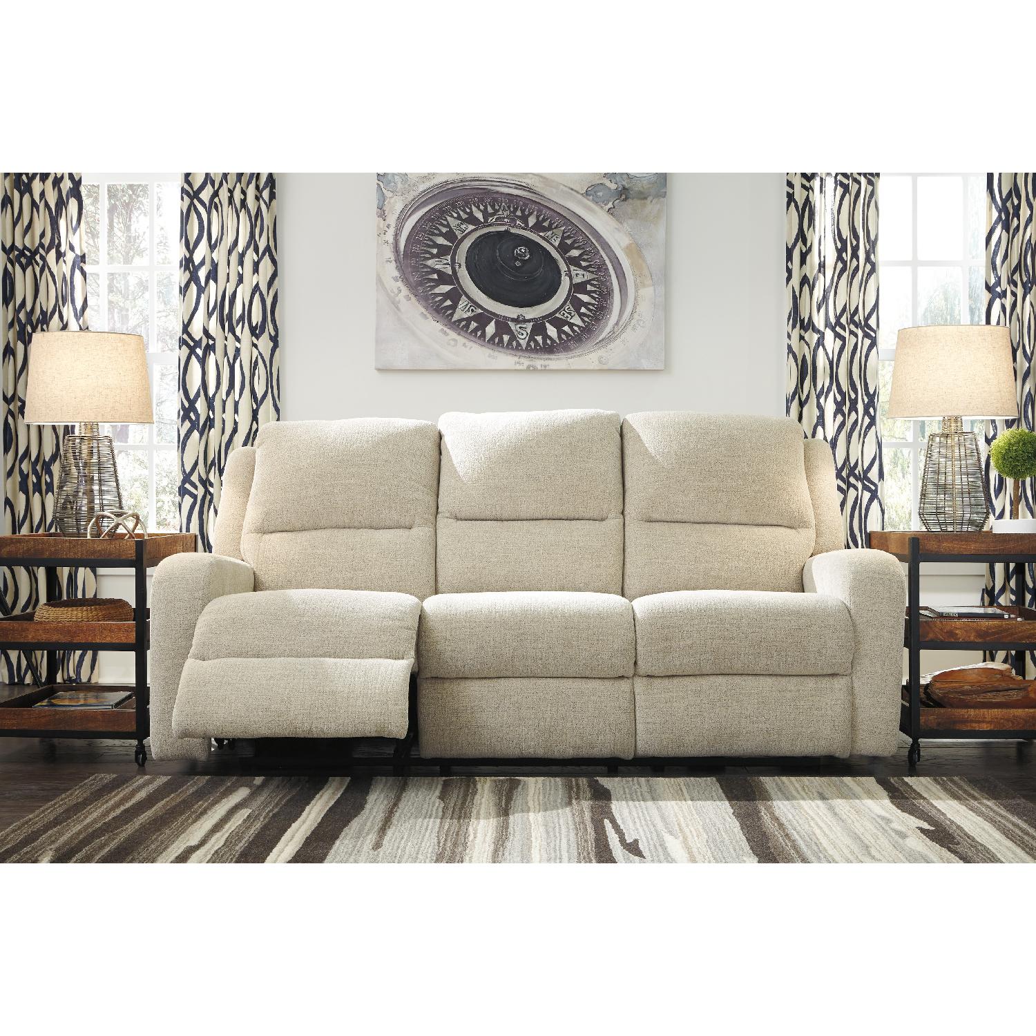 Ashley's Krismen Contemporary Power Reclining Sofa w/ Adjustable Headrest in Ivory Fabric - image-3