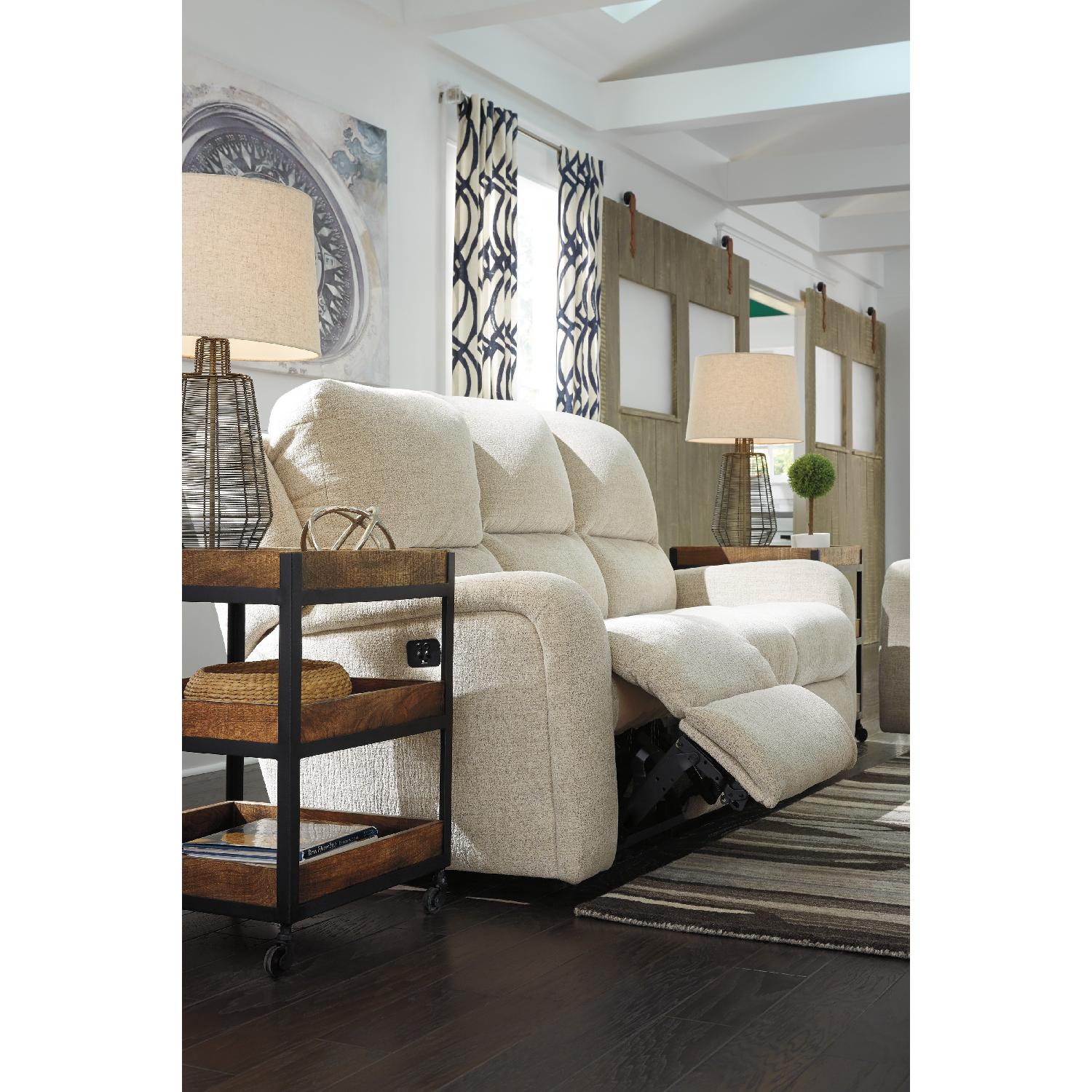 Ashley's Krismen Contemporary Power Reclining Sofa w/ Adjustable Headrest in Ivory Fabric - image-5