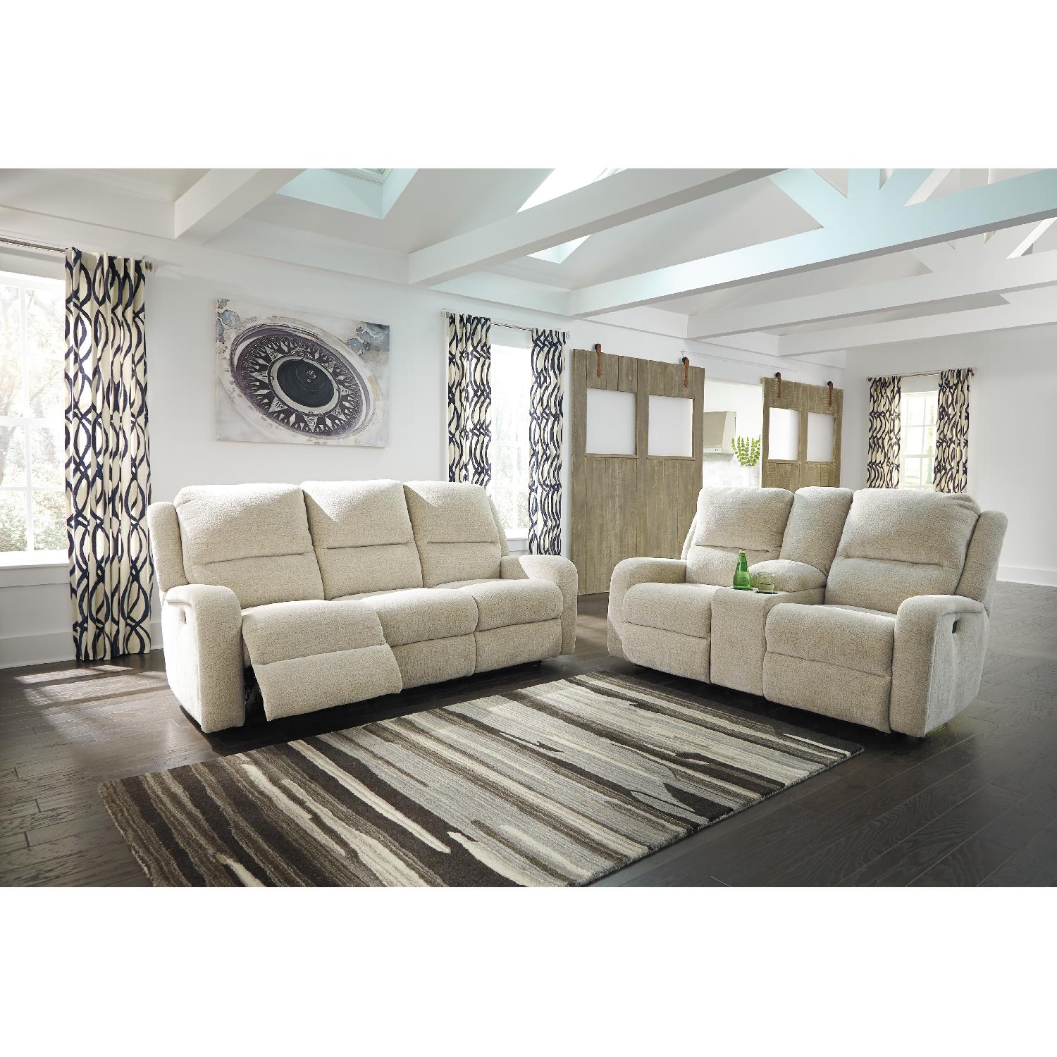 Ashley's Krismen Contemporary Power Reclining Sofa w/ Adjustable Headrest in Ivory Fabric - image-9